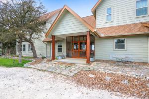 a house with a porch with a table and chairs at Casa Robles- The Bluebonnet in Wimberley +17 photos