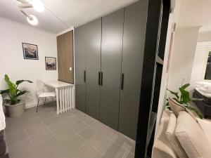 a room with a cabinet and a table and a desk at Sydney Homestay in Mölndal +14 photos