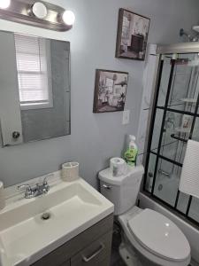 a bathroom with a sink and a toilet and a mirror at Private guest rooms & baths in Atlanta