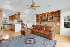 a living room with a couch and a kitchen at Casa Robles- The Mockingbird in Wimberley