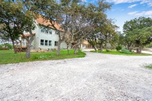 an empty driveway in front of a house at Casa Robles- The Mockingbird in Wimberley