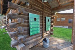a wooden cabin with two signs on the wall at Wimberley Log Cabins Resort and Suites- Unit 8 in Wimberley +6 photos