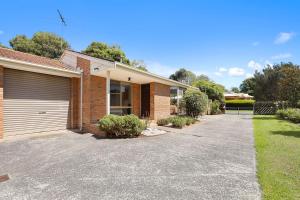 a brick house with a garage and a driveway at Cowes Monash Hideaway in Cowes