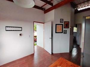 a hallway with white walls and a white door at Casa Naranja in Máncora