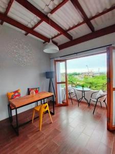 a living room with a wooden table and chairs at Casa Naranja in Máncora