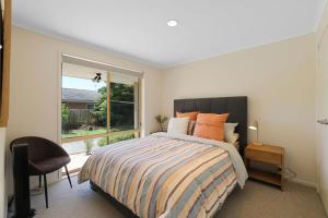 a bedroom with a large bed and a window at Cowes Monash Hideaway in Cowes