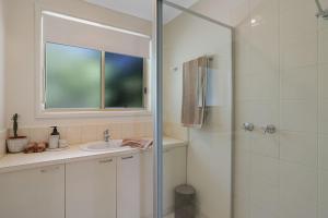 a bathroom with a shower and a sink at Cowes Monash Hideaway in Cowes