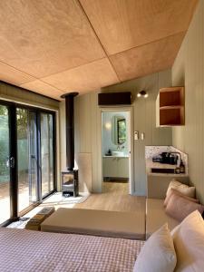 a living room with a couch and a stove at The Flower Sanctuary Tiny Home in Springbrook
