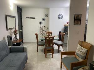 a living room with a couch and a table and chairs at Reservas del peñon in Girardot
