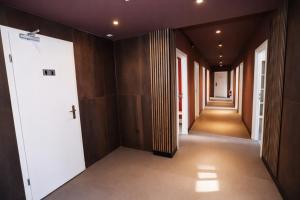 a hallway of a building with wooden walls and doors at NIVAN Hostel in Hamburg