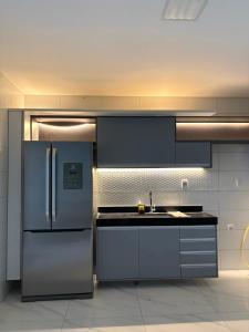 a kitchen with a stainless steel refrigerator and a sink at Green House in Juazeiro do Norte