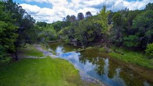 an aerial view of a river with trees at Clearwater Log Home in Wimberley
