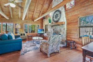 a living room with a couch and a fireplace at Clearwater Log Home in Wimberley +25 photos