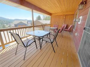 a porch with a table and chairs on a deck at Prospector in Hill City +13 photos