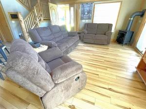 a living room with a couch and two chairs at Granite Ridge Cabin in Keystone