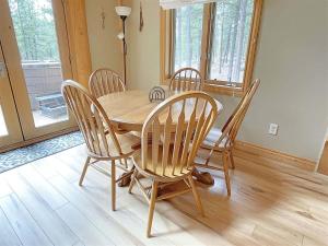 a wooden table and chairs in a dining room at Granite Ridge Cabin in Keystone