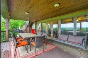 a screened in porch with a table and chairs at Clutter Falls Retreat - Main House in New Braunfels
