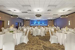 a banquet room with white tables and chairs and a stage at Best Western Holiday Lodge in Clear Lake +44 photos