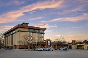 a building with cars parked in a parking lot at Best Western Holiday Lodge in Clear Lake