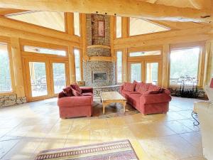 a living room with two red couches and a fireplace at Granite Ridge Lodge in Keystone