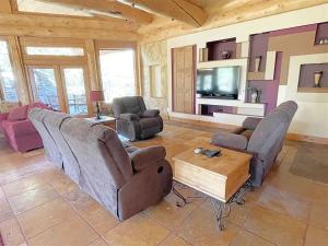 a living room with two couches and a tv at Granite Ridge Lodge in Keystone +33 photos