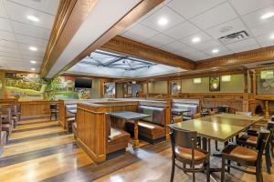 a dining room with wooden tables and chairs at Best Western Holiday Lodge in Clear Lake
