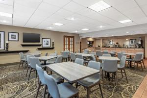 a classroom with tables and chairs and a tv at Best Western Holiday Lodge in Clear Lake