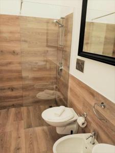a bathroom with a toilet and a glass shower at Hotel Noto Marina Meeting Vista Mare in Noto Marina