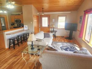 a living room with a couch and a table at Iron Horse Lookout in Hill City