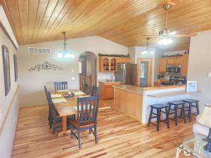 a kitchen and dining room with a table and chairs at Iron Horse Lookout in Hill City