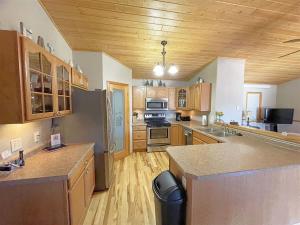 a large kitchen with wooden cabinets and a counter top at Iron Horse Lookout in Hill City