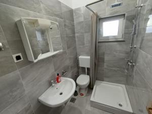 a bathroom with a sink and a toilet and a shower at Kuća za odmor STIPE in Pag +44 photos