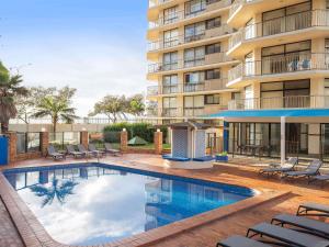 a swimming pool in front of a building at BreakFree Imperial Surf in Gold Coast