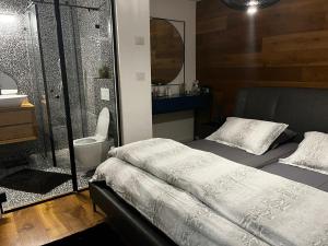 a bedroom with a bed and a shower and a sink at Sea180 in Nahariyya +43 photos
