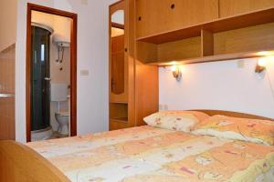 a bedroom with a bed with a map on it at Kuća za odmor STIPE in Pag