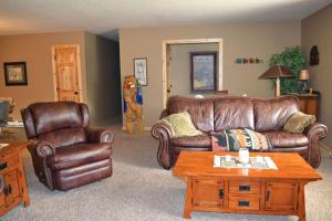 a living room with a leather couch and a table at Keystone Crossing in Keystone