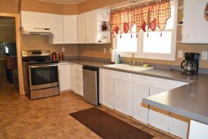 a kitchen with white cabinets and a stove top oven at Keystone Crossing in Keystone +17 photos