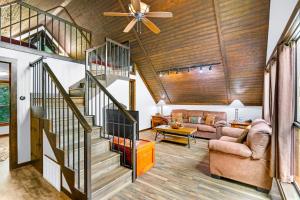 a living room with a staircase and a ceiling fan at Clutter Falls Retreat - Guest House in New Braunfels