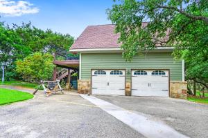a house with two garage doors and a porch at Clutter Falls Retreat - Guest House in New Braunfels +22 photos