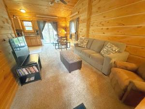 a living room with a couch and a table at Schuster's Cabin in Custer