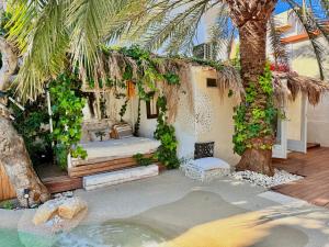 a patio with a massage table and a palm tree at Casa Klod Ibiza in Ibiza Town