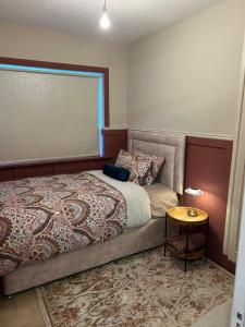 a bedroom with a bed and a side table at The Greenway Getaway in Abbeyside