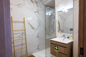 a bathroom with a shower and a sink and a mirror at Trio Living Residences in Vila Real +104 photos