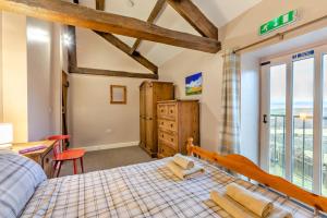 a bedroom with a bed and a desk and a window at 2 Bed in Eggleston oc-l30452 in Middleton in Teesdale