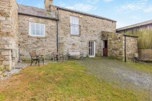 a stone house with two chairs and a building at 2 Bed in Eggleston oc-l30452 in Middleton in Teesdale