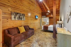 a living room with a couch and a bed at Wimberley Log Cabins Resort and Suites- Unit 3 in Wimberley