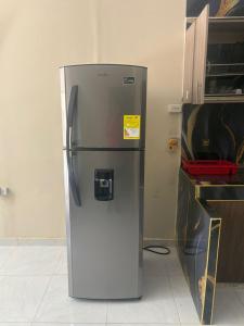 a refrigerator is sitting in a room at Apartamentos KARS in Ríohacha