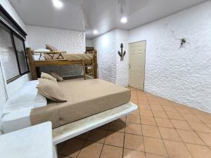 a bedroom with two bunk beds in a room at Candelaria 5 Moterrico in Taxisco +48 photos