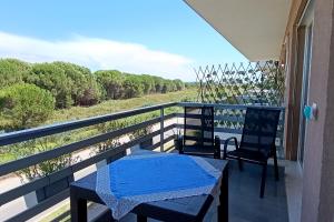 a balcony with two chairs and a table and a view at Sophi's Dream Apartment in Lalzit Bay