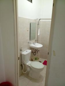 a bathroom with a toilet and a sink at Mamita Seaside Resort in Guinisiliban
